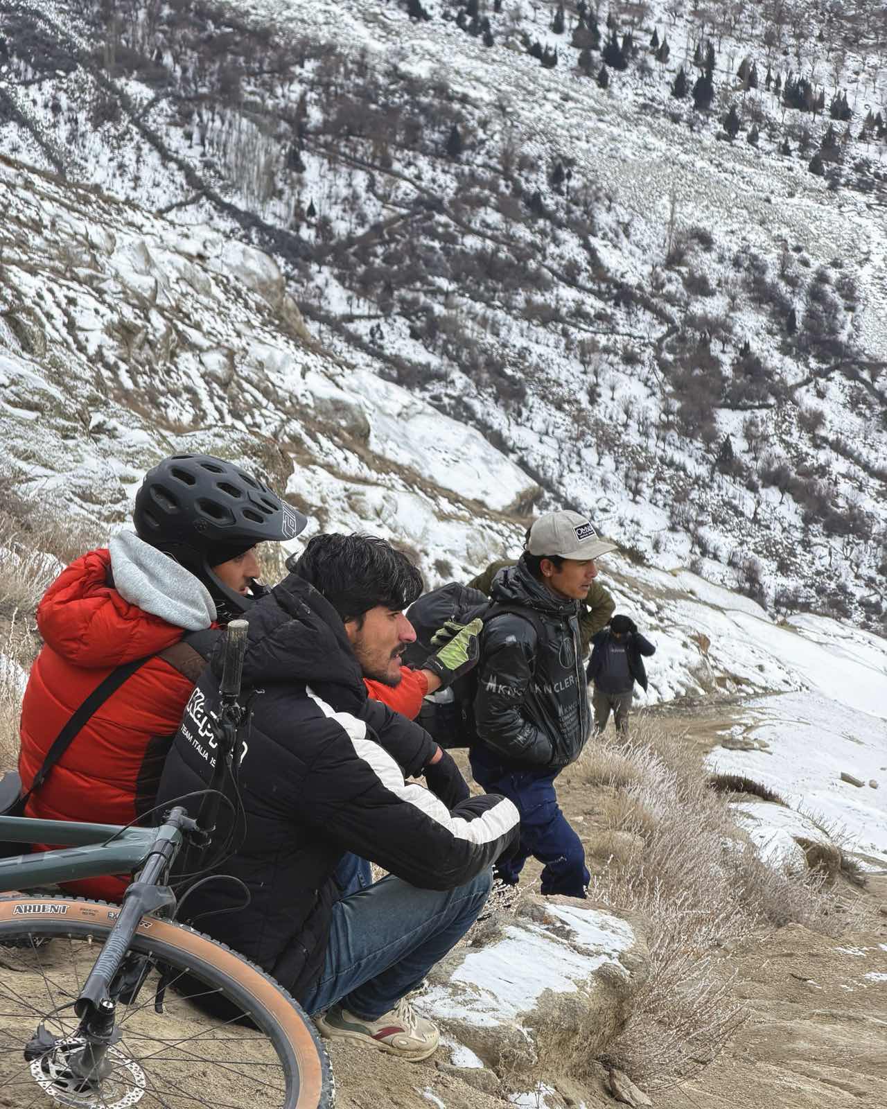 Arsalan sitting with Hassnain and Broko on a frozen slope
