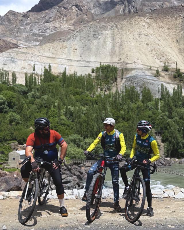 Three riders pausing together on the road